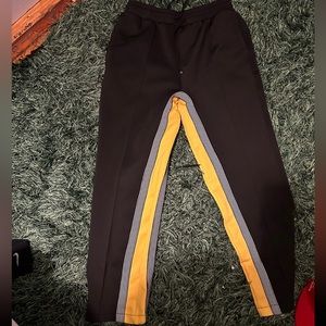 Black and yellow track pants